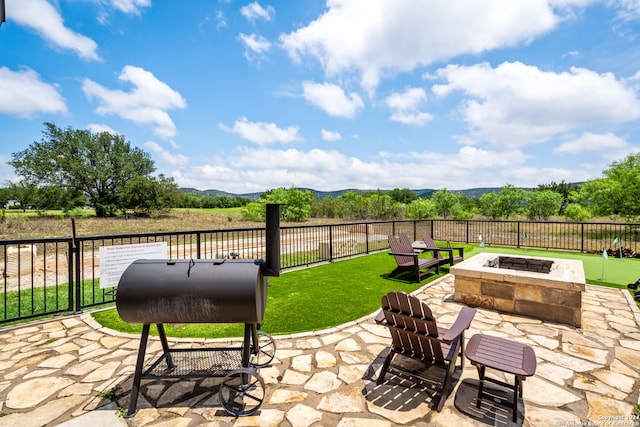 view of patio / terrace featuring an outdoor fire pit