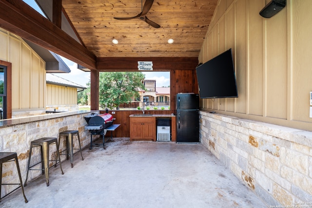 view of patio with ceiling fan and an outdoor wet bar