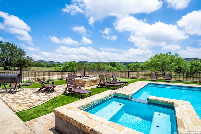 view of swimming pool with an in ground hot tub and a patio area