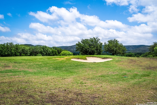 view of community featuring a lawn and a mountain view