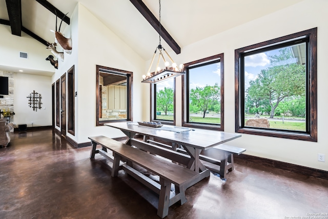 dining room featuring beamed ceiling, concrete floors, and plenty of natural light