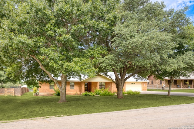 view of front of home with a front lawn and a garage