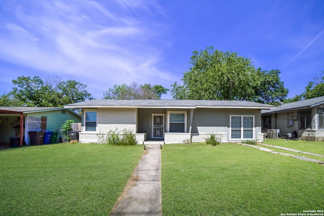 single story home featuring brick siding, a front lawn, and central AC unit