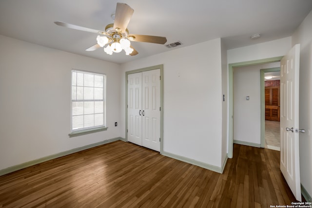 unfurnished bedroom with hardwood / wood-style floors, a closet, and ceiling fan