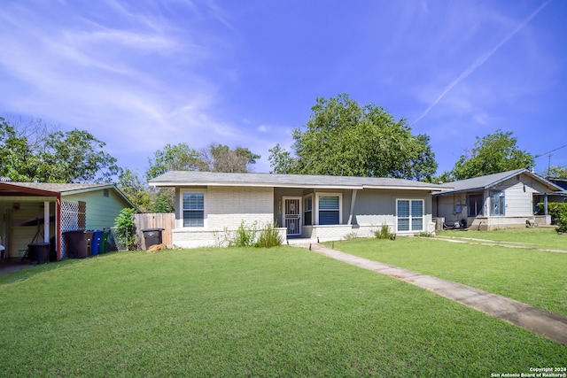 ranch-style house featuring a front yard and brick siding