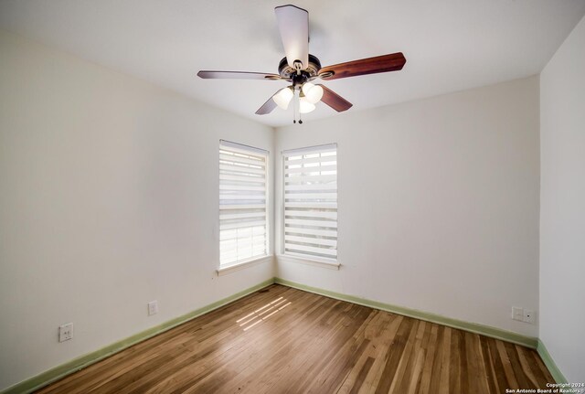 unfurnished room featuring hardwood / wood-style floors and ceiling fan