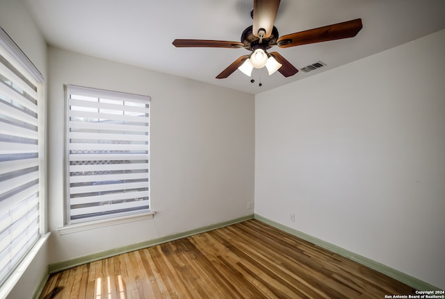 empty room featuring ceiling fan and hardwood / wood-style flooring