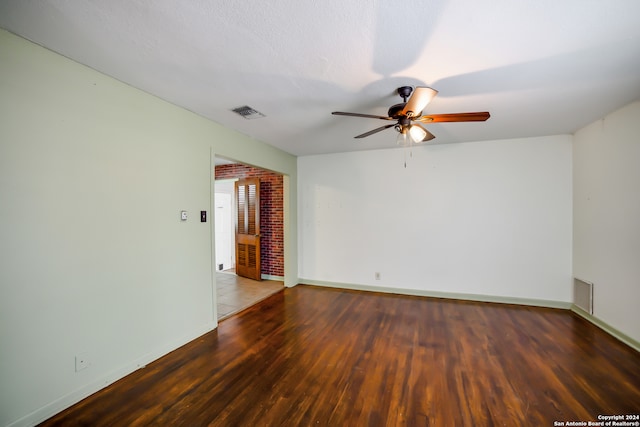 empty room with ceiling fan and wood-type flooring