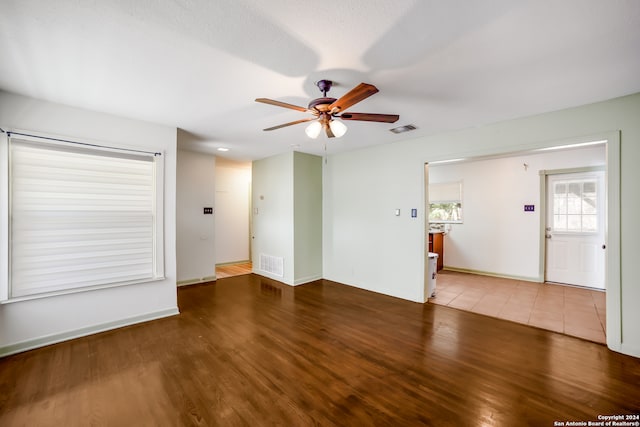 interior space with ceiling fan and wood-type flooring