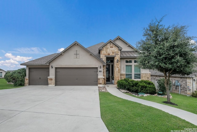 view of front of house featuring stucco siding, a garage, stone siding, driveway, and a front lawn