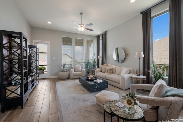 living room featuring a wealth of natural light, light hardwood / wood-style flooring, and ceiling fan