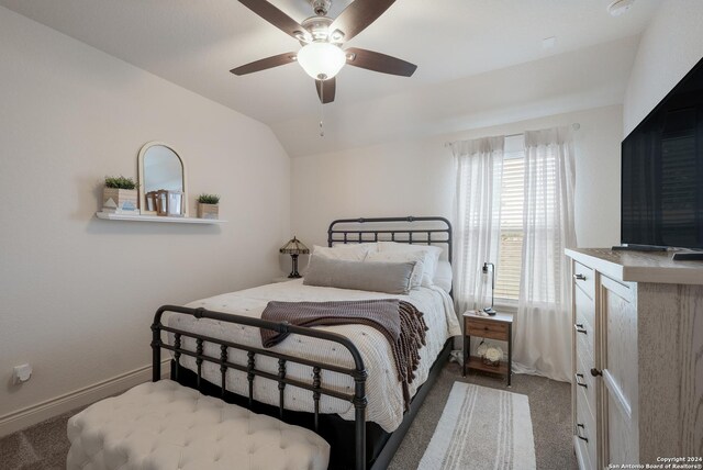 bedroom featuring ceiling fan, vaulted ceiling, and carpet floors