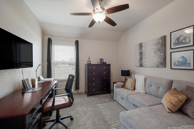 carpeted home office with ceiling fan and lofted ceiling