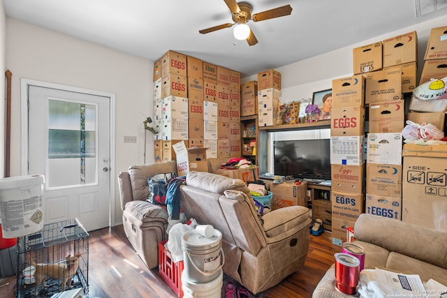 living room with ceiling fan and dark hardwood / wood-style floors