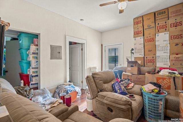 living room with ceiling fan, hardwood / wood-style floors, and electric panel