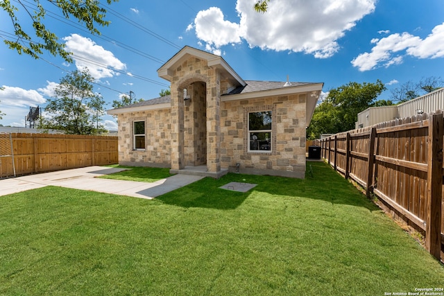 back of house featuring a lawn