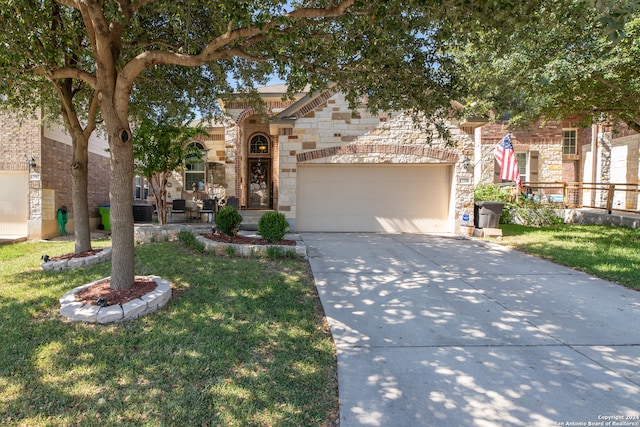 view of front of property with a garage, central AC, and a front yard