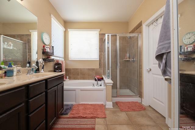 bathroom featuring plus walk in shower, tile patterned flooring, and vanity