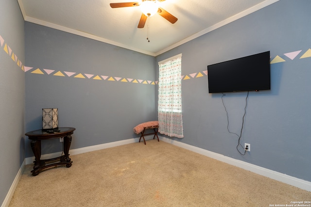 sitting room with ceiling fan, carpet floors, and crown molding