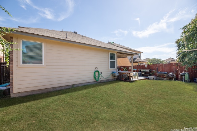 rear view of house featuring a patio and a yard