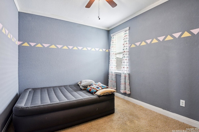 carpeted bedroom with ceiling fan and crown molding