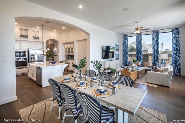 dining room with ceiling fan and dark hardwood / wood-style flooring