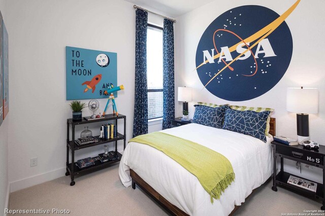 carpeted bedroom featuring multiple windows