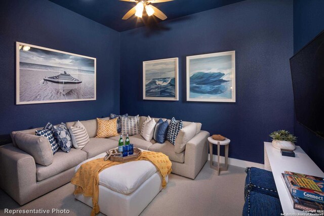 living room with ceiling fan and carpet