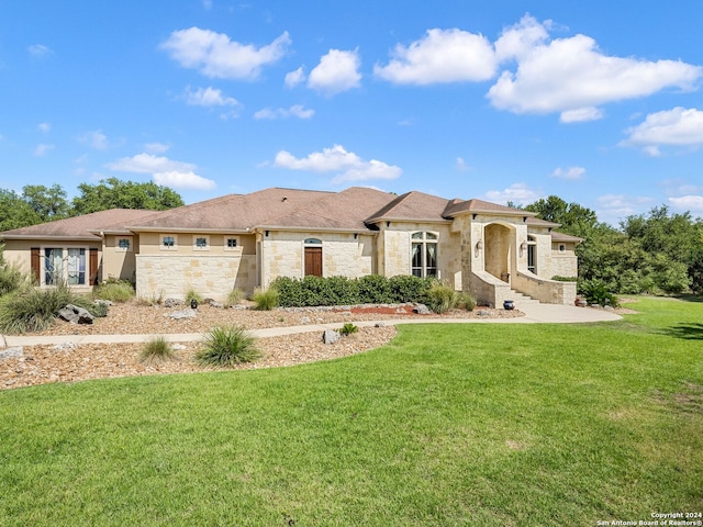 view of front facade featuring stone siding and a front yard