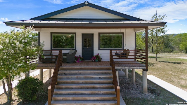 exterior space with a standing seam roof, metal roof, and covered porch