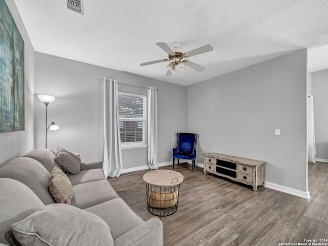 living room with ceiling fan and wood-type flooring