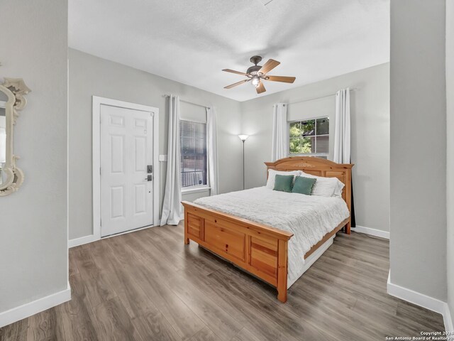 bedroom featuring hardwood / wood-style floors and ceiling fan