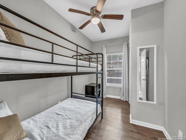 bedroom featuring dark hardwood / wood-style flooring and ceiling fan