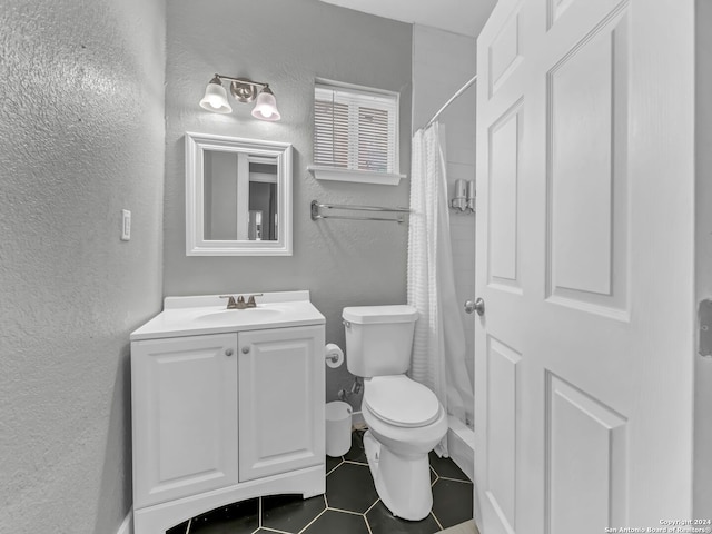 bathroom featuring tile patterned floors, vanity, and toilet