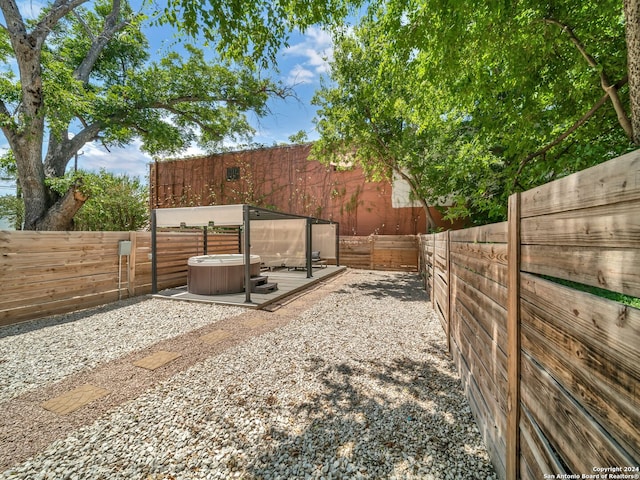 view of yard with a patio area and a hot tub