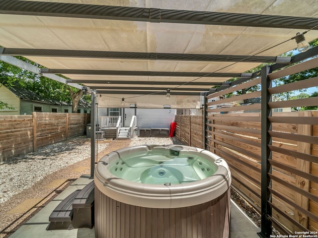 view of patio / terrace with a hot tub