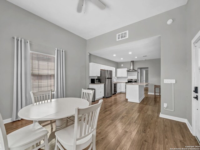 dining space featuring ceiling fan and wood-type flooring