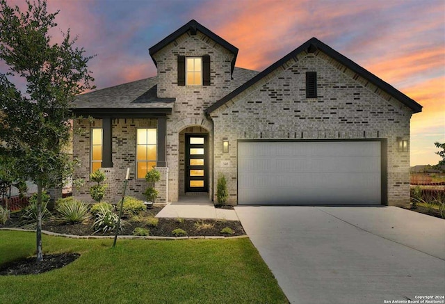 view of front of house with a lawn and a garage