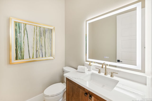 bathroom with toilet and vanity