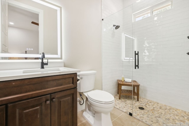 full bathroom with tile patterned flooring, a shower stall, toilet, and vanity