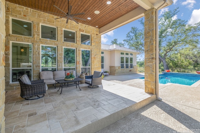 view of patio / terrace featuring an outdoor living space, a ceiling fan, and an outdoor pool