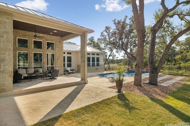 view of patio featuring a ceiling fan, a fenced in pool, and an outdoor hangout area