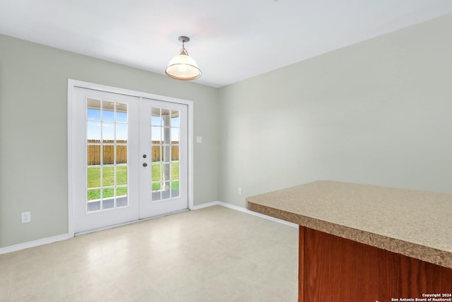 doorway featuring french doors and baseboards