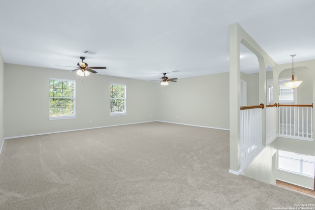 carpeted empty room featuring ceiling fan