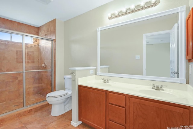 bathroom with a sink, a shower stall, and toilet