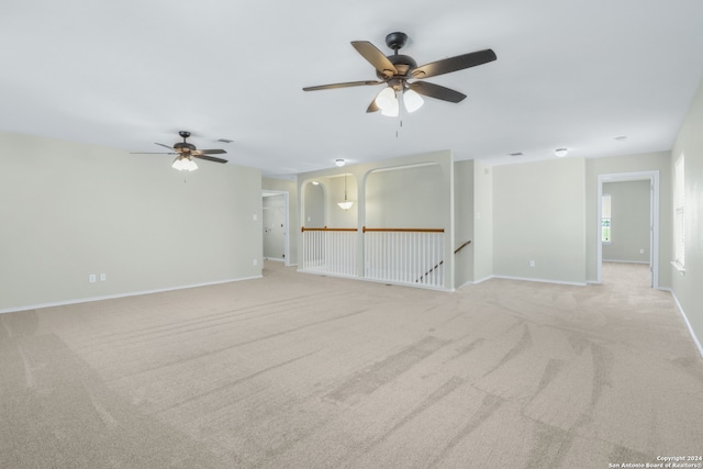 carpeted spare room with ceiling fan