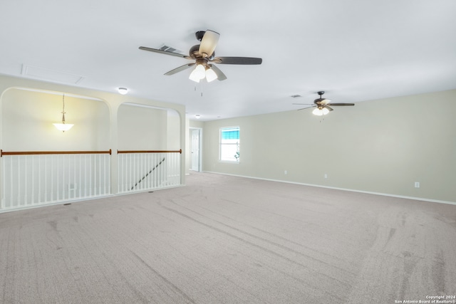 carpeted spare room featuring ceiling fan