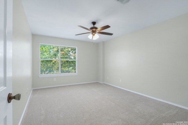 empty room with ceiling fan and carpet flooring