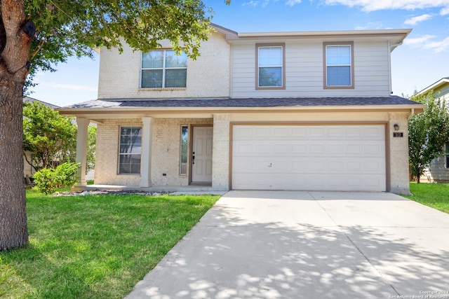 traditional-style home featuring a garage, a front yard, concrete driveway, and brick siding