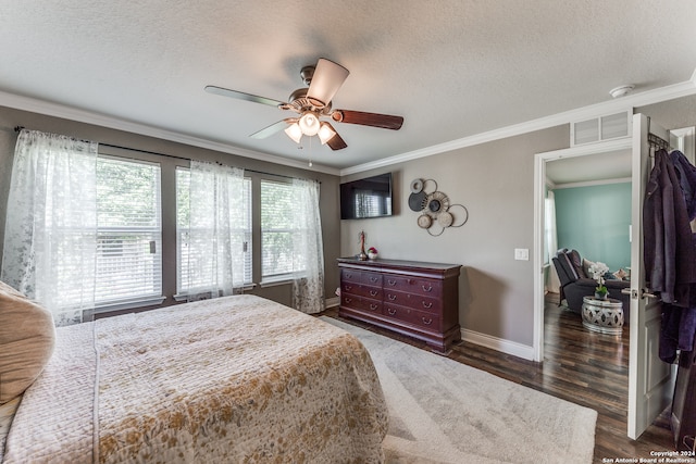 bedroom with ceiling fan, a textured ceiling, crown molding, and dark wood-type flooring